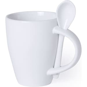 A white coffee mug with a unique handle design that includes a matching spoon.