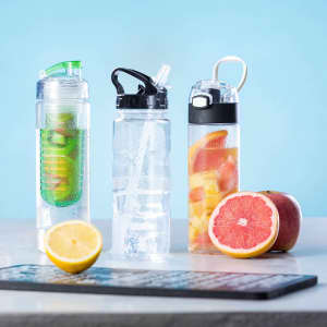 A drink bottle collection featuring clear bottles with green, black, and fruit-infused designs, alongside fresh fruit slices.