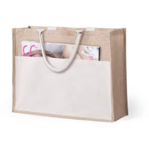 A beige tote bag with handles, featuring an exterior pocket and a magazine partially visible inside. It has a logo.