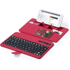 A red keyboard holder with a black keyboard and slots for cards, featuring a space for a phone.