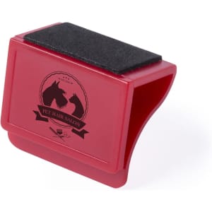 A red pet hair removal tool with a black velvety surface and a logo featuring two horse silhouettes.