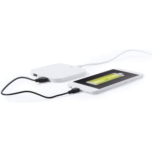 A white wireless charger connected to a smartphone, featuring a minimalist design with a USB cable.