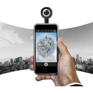 A hand holds a smartphone with a 360° camera attached, displaying a panoramic cityscape on the screen.