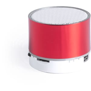 A compact round speaker in red and silver with a mesh grille on top and a branding logo.