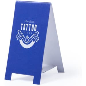 A blue A-frame sign featuring a tattoo salon logo, with a clean and simple design.