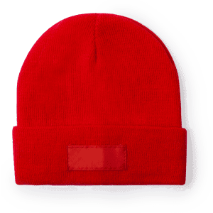 A red beanie hat featuring a fold-over cuff and a plain patch area, suitable for branding or labels.