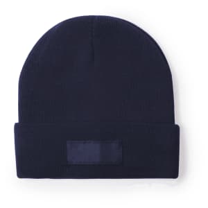 A navy beanie with a folded brim and a patch area, featuring a simple design and a fitted shape.