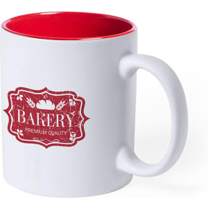 A white coffee mug with a red interior, featuring a logo on the front.