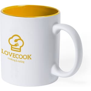 A white coffee mug with a yellow interior and a logo on the front.