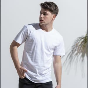 A white adult T-shirt displayed on a model with short sleeves and a casual pose against a plain background.