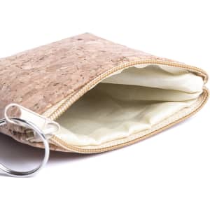 A beige cork purse with a zippered closure, featuring a light-coloured interior lining and a metal ring.