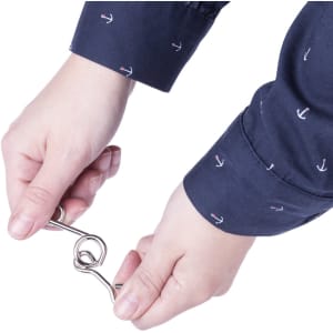 A pair of hands holds a silver metal hook, featuring a shirt with a navy background and anchor patterns.