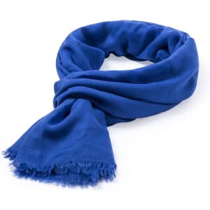 A blue scarf with frayed edges, neatly arranged in a loop. The fabric appears soft and lightweight.