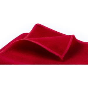 A red absorbent towel with a soft texture, featuring a fold at the corner. It has a logo present.