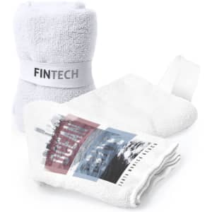 A white absorbent towel with a branded band and a design featuring ocean and beach imagery.