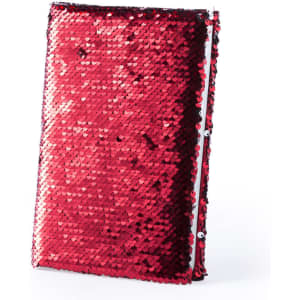 A sparkling red notepad covered in sequins, featuring a clasp on the side and a logo on the front.