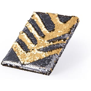 A notepad featuring a black and gold sequinned cover with a geometric pattern. It has a shiny, textured finish.