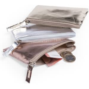 Three metallic purses in rose gold, silver, and gold stacked together, featuring zippers and containing coins and cards.