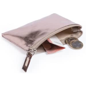 A rose gold purse with a zippered opening, containing coins and folded banknotes. It has a smooth, shiny finish.