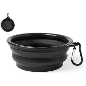 A foldable black bowl with a carabiner clip, designed for pet use. It features a smooth interior and ridged exterior.