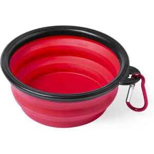 A foldable bowl in red with a black rim, featuring a carabiner for easy attachment.