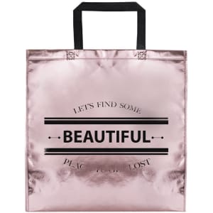 A rose gold bag with a black handle and a branding logo, featuring the text "Let's find some beautiful places to get lost."