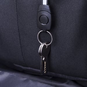 A black backpack featuring a keyring with keys attached, showcasing its anti-theft design.