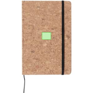 A cork notepad with a black elastic band and a small green square on the front cover.