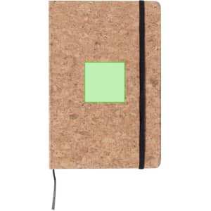 A cork notepad with a black elastic band, featuring a green square patch.