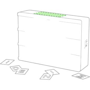 A rectangular light box in white with a green top and scattered letter tiles beside it.