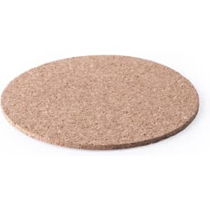 A round, natural cork coaster with a smooth surface, featuring a simple, unbranded design.