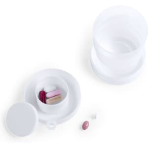 A foldable cup in white accompanied by a small pill compartment containing various coloured capsules.