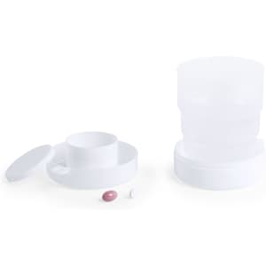 A foldable white cup with two compartments and a lid, accompanied by two small coloured pills.