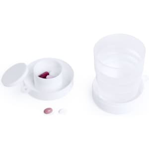 A foldable cup in white, accompanied by a few colourful pills and a lid. The cup has a simple design and logo.