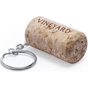 A cork-shaped keyring with a silver metal chain, featuring a logo. The keyring is a natural cork colour.