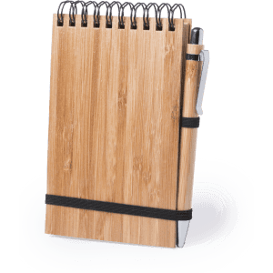 A bamboo notebook with a spiral binding and a pen attached, secured with a black elastic band.