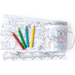 A white mug with a colouring design beside a sheet of illustrated paper and colourful pencils.
