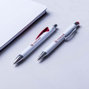 Two metal pens in white, one with a red clip and the other with a red accent, alongside a notepad. Both feature branding.