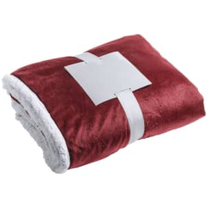 A plush, red blanket with a white underside, neatly folded and secured with a white band, featuring a logo.