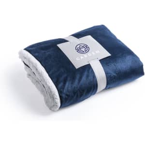 A navy blue blanket with a soft, light grey underside, wrapped with a branded label.