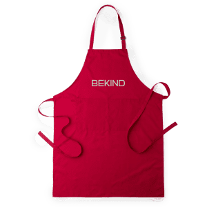 A red apron with adjustable straps and a front pocket, featuring a logo at the top.