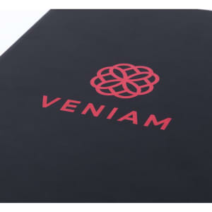A black notepad featuring a red logo and the word "VENIAM."