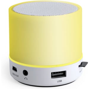 A yellow and white cylindrical speaker with a mesh top, featuring USB and AUX ports on the side.