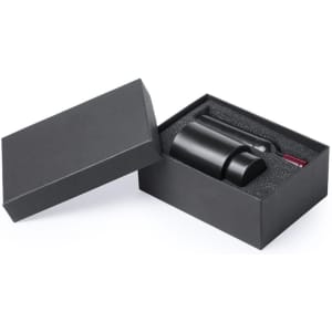 A black wine set in a sleek box, including a bottle and accessories, featuring a polished design and foam insert.