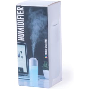 A humidifier in a white box, featuring a colour-changing design and emitting steam. The box has a logo.