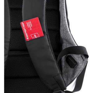 A black and grey backpack featuring a pocket for a card on the strap, with a textured back panel.