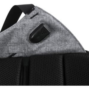 A grey backpack with a textured surface and a small black logo or branding on the strap.