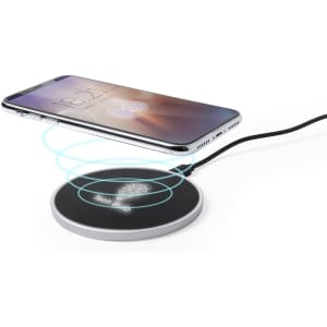 A wireless charger in silver with a smartphone placed above it, featuring energy wave graphics.