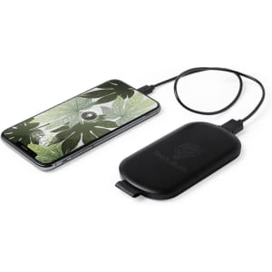 A black Simmon Power Bank sits beside a smartphone displaying a leafy design, connected by a charging cable.