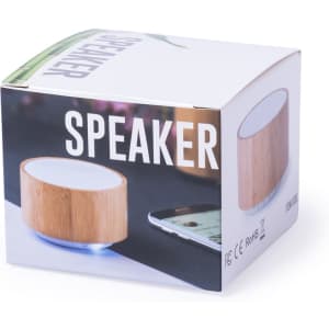 A speaker in a bamboo design with a white top, displayed in an open box featuring logos and branding.